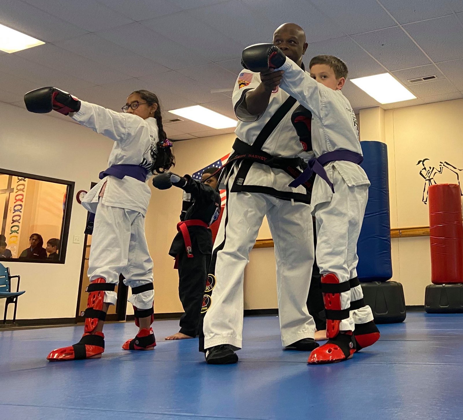 Kyoshi Roger Dabney teaching kids punching technique at Competitive Edge Karate in Henrico, VA